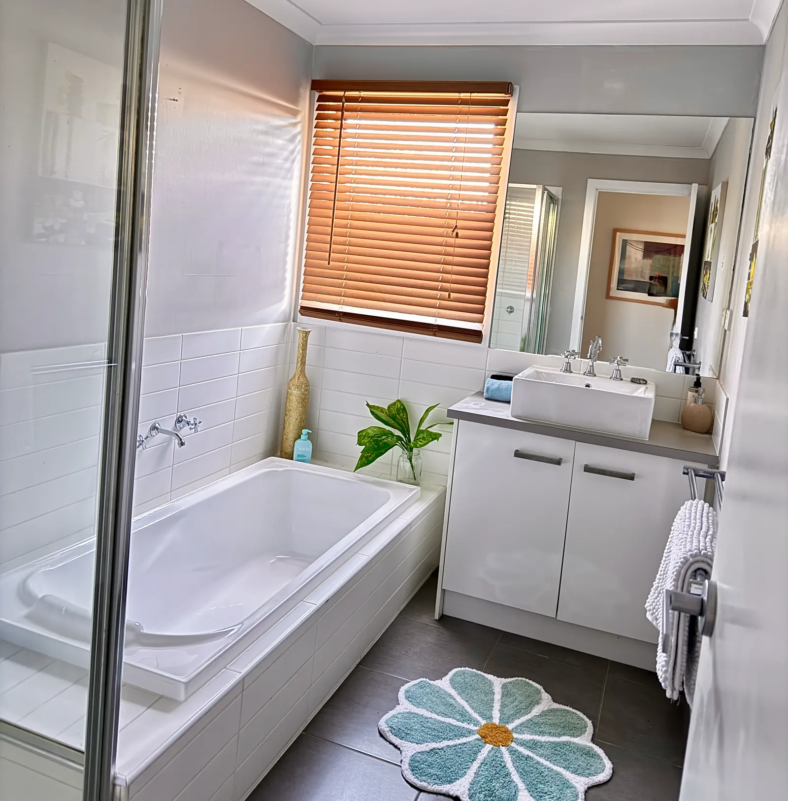 Bathroom with bathtub, shower and a window fitted with a timber blind — Coastal Tones holiday home, Cowes, Phillip Island