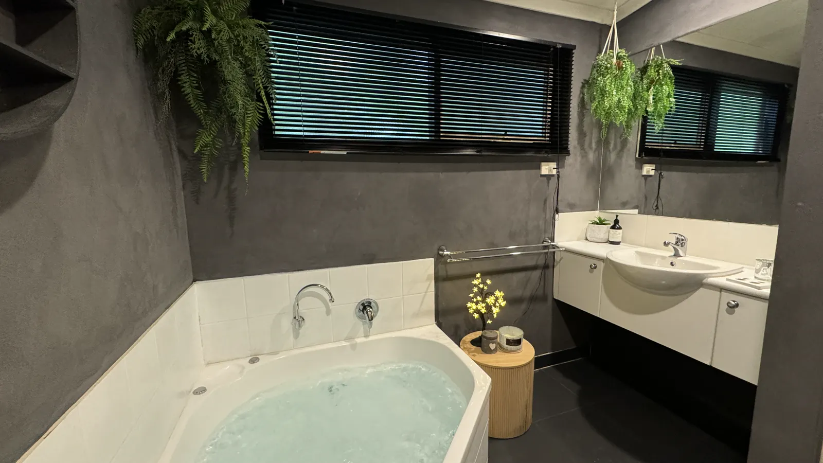 Private spa bath beside the bathroom vanity and hanging plants — Studio Spa Villa 127, Cowes, Phillip Island
