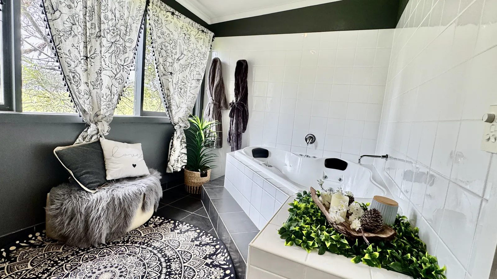 Romantic private spa room with a cushioned chair and leafy window outlook — Couples Private Spa Retreat Villa 117, Cowes, Phillip Island