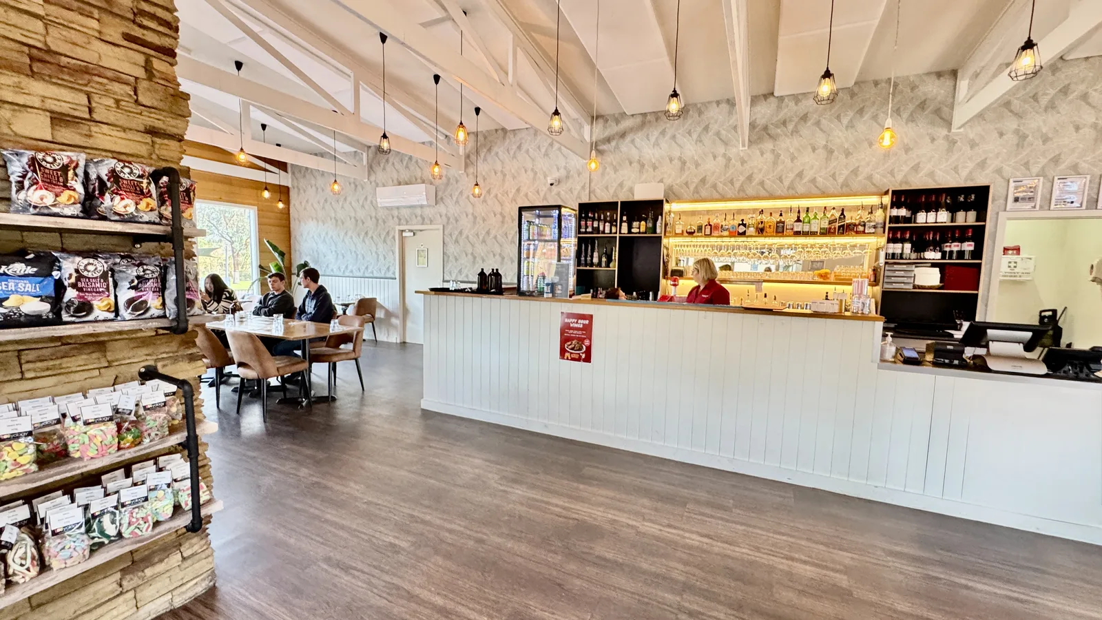 Resort restaurant and bar counter with indoor dining tables
